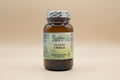 Brown bottle with a green label, "Opal 100% Vegetarian Chaga," on a beige background.